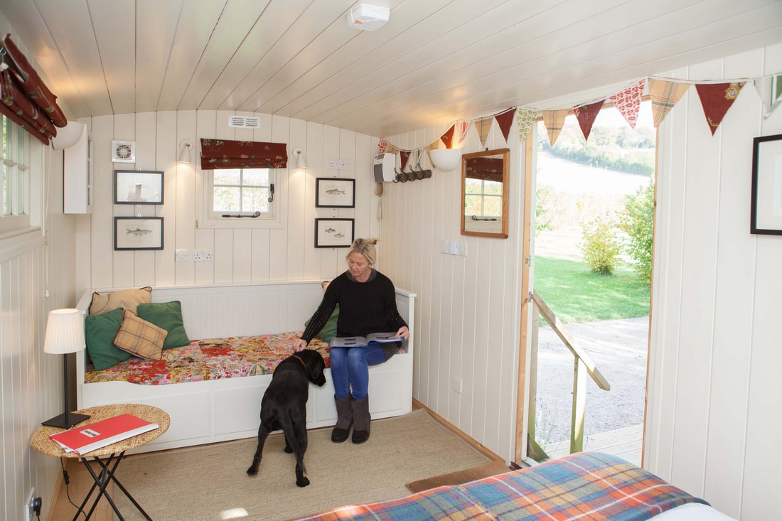 Shepherd's Hut interior, lady with dog